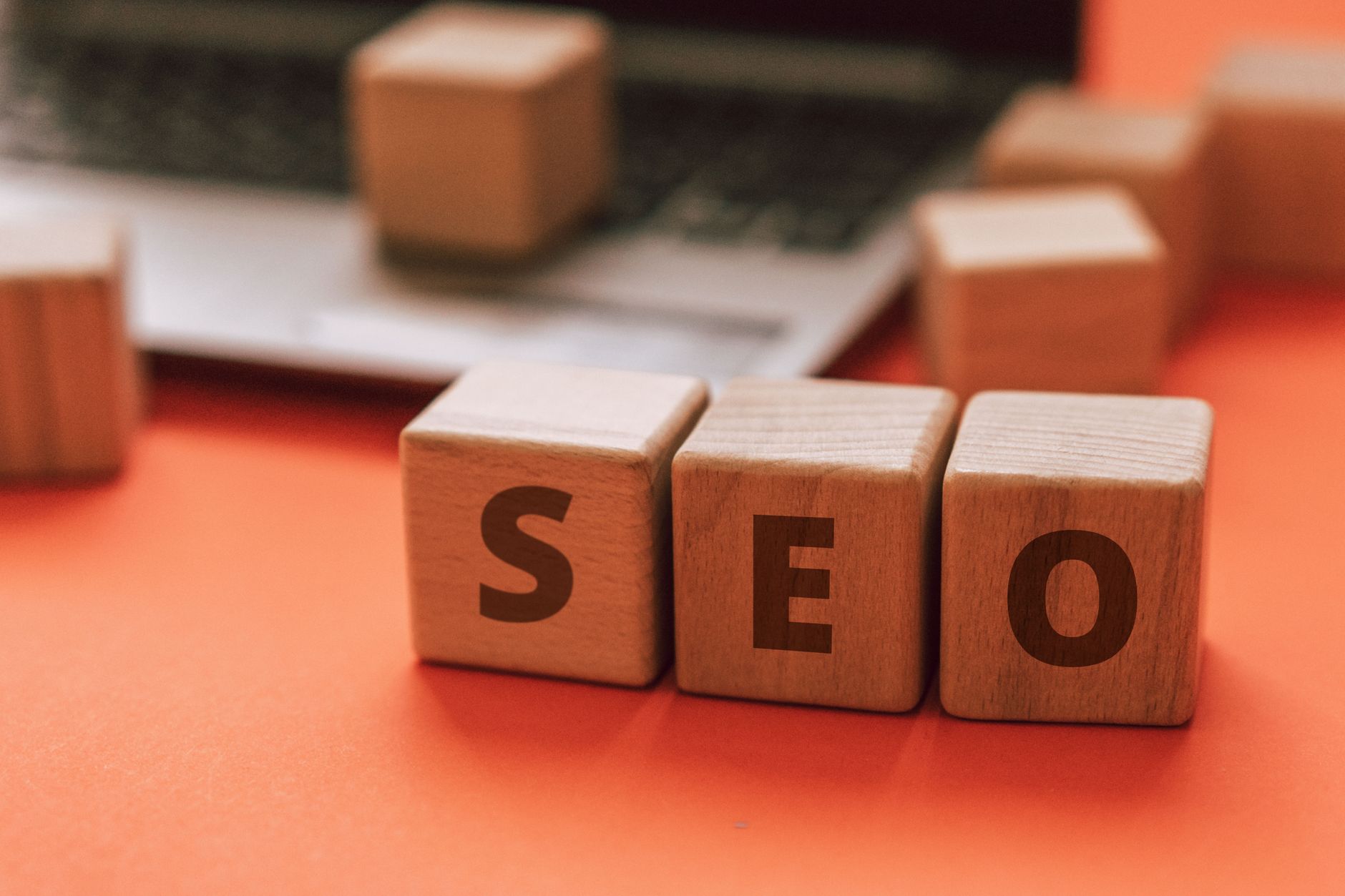 Small business owner reviewing SEO audit checklist on laptop showing small business SEO mistakes